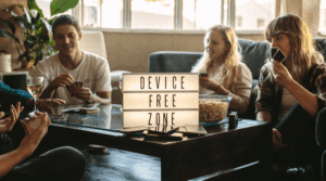 group of people playing cards in the middle of a sign saying digital detox